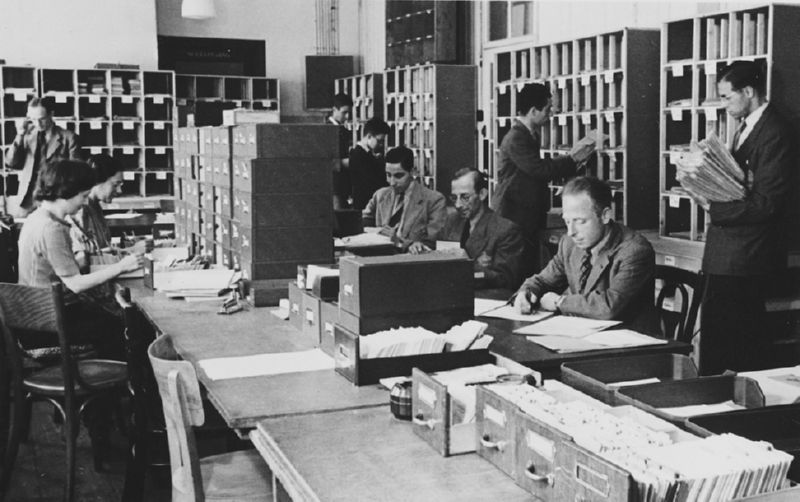 Workers sort and file papers and cards in the offices of the Joodse Raad in Amsterdam